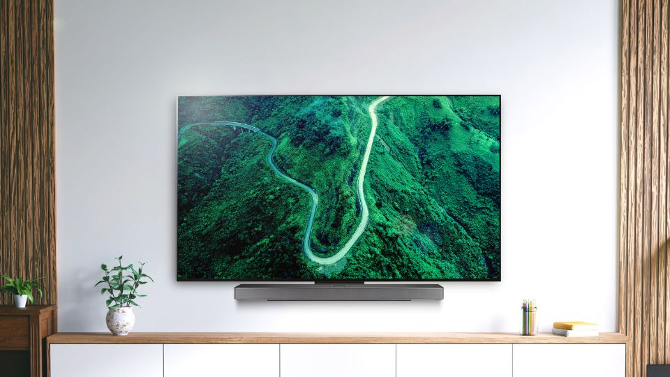 An image of the new LG OLED C3 series and matching soundbar mounted on a wall using the LG synergy bracket. 